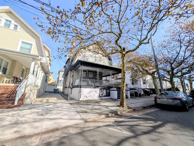 a view of a patio with table and chairs and wooden floor
