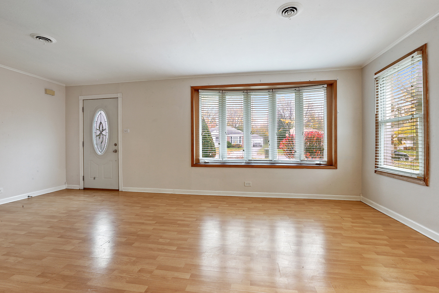 17614 Howe Avenue Homewood, IL 60430 - Photo 3 of 11 an empty room with wooden floor and windows