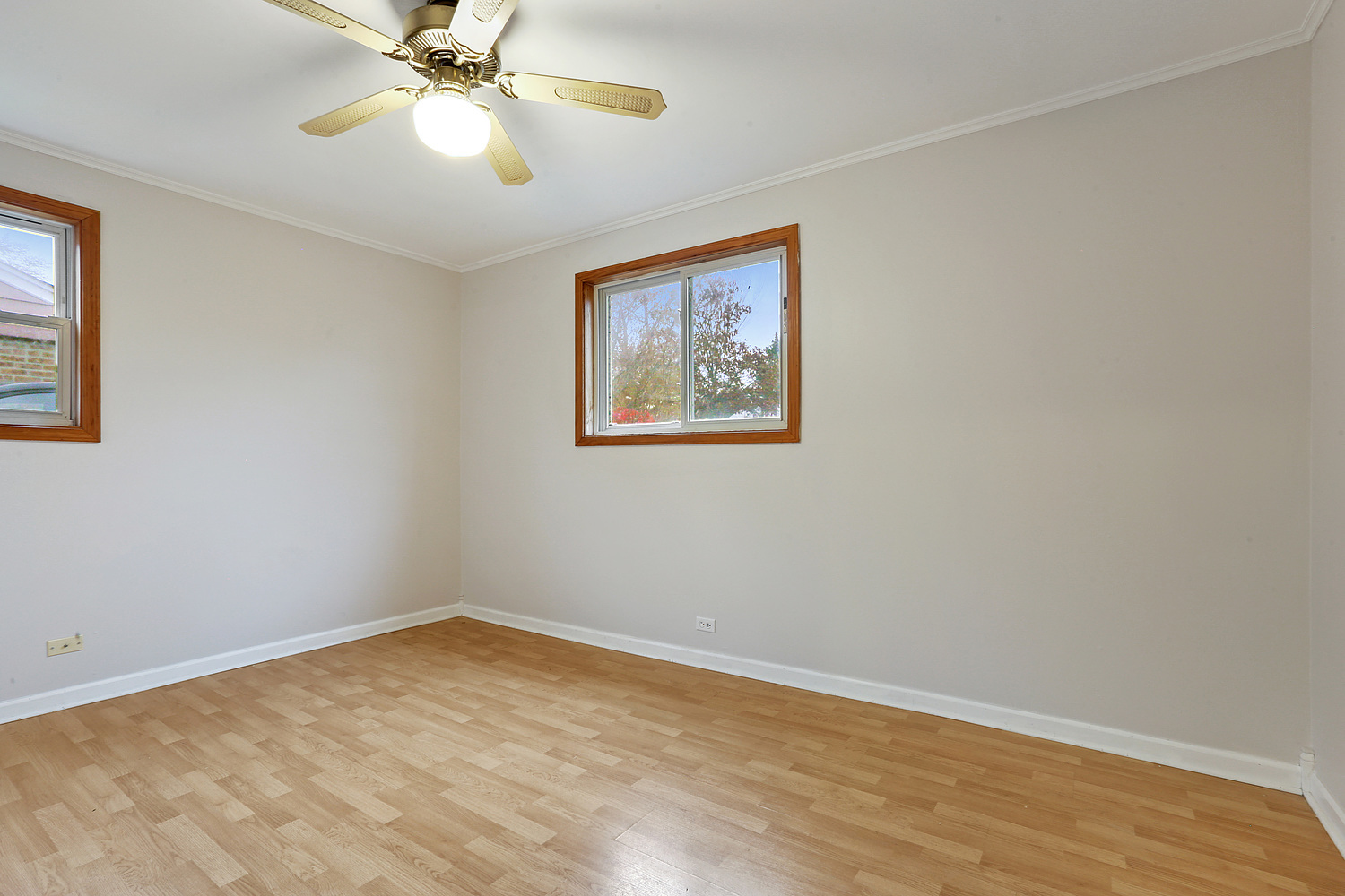 17614 Howe Avenue Homewood, IL 60430 - Photo 6 of 11 a view of an empty room with a window and wooden floor