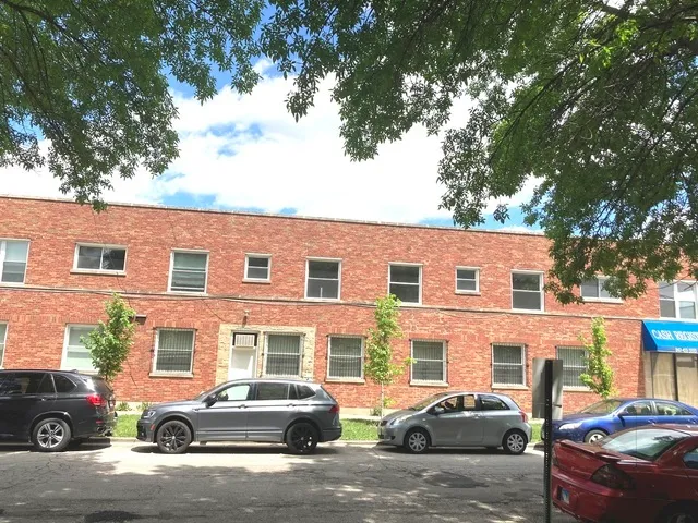 a car parked in front of a brick house