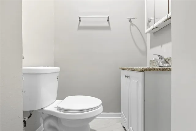a white toilet sitting next to a bathroom sink