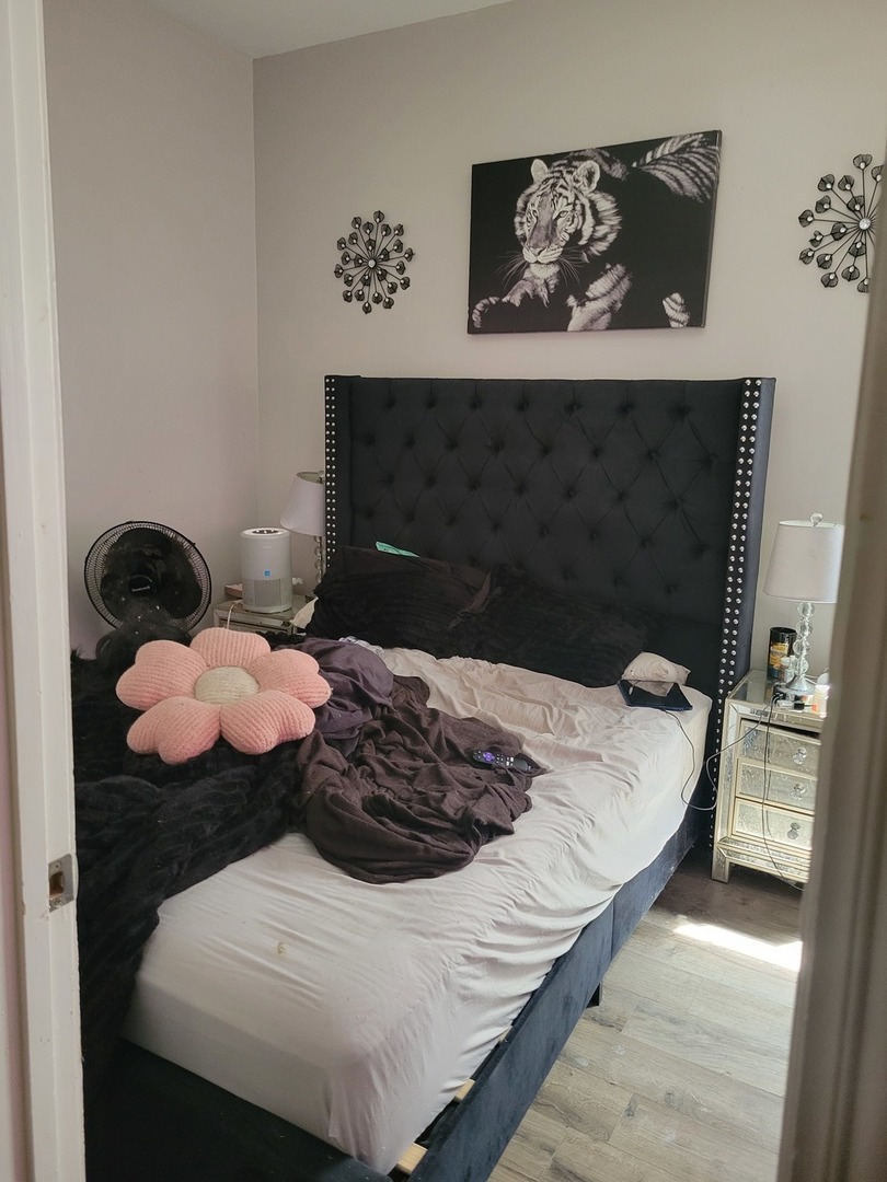 6016 South Carpenter Street Chicago, IL 60621 - Photo 13 of 15 a bed sitting in a bedroom and dresser