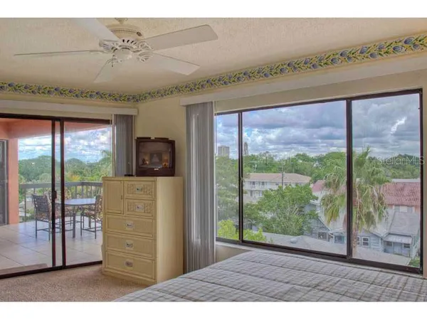 a hallway with a large window and a bed