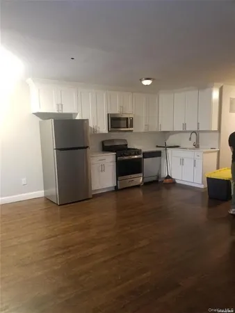 a kitchen with a sink a stove a refrigerator and a microwave