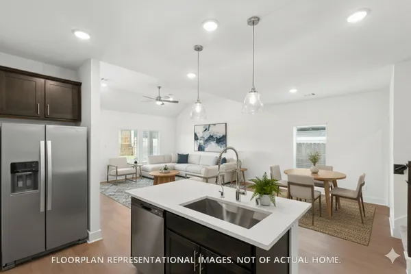 a kitchen with a sink stove and cabinets