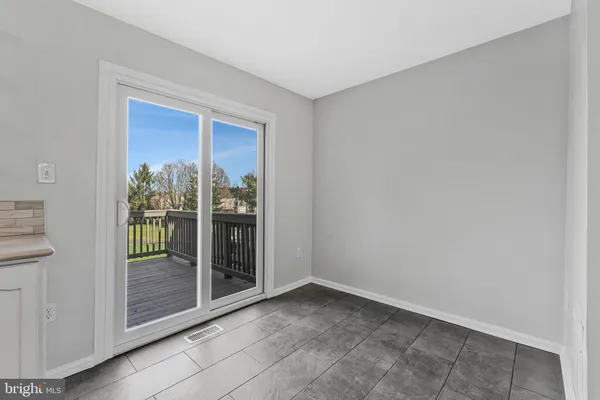 a view of an entryway with wooden floor