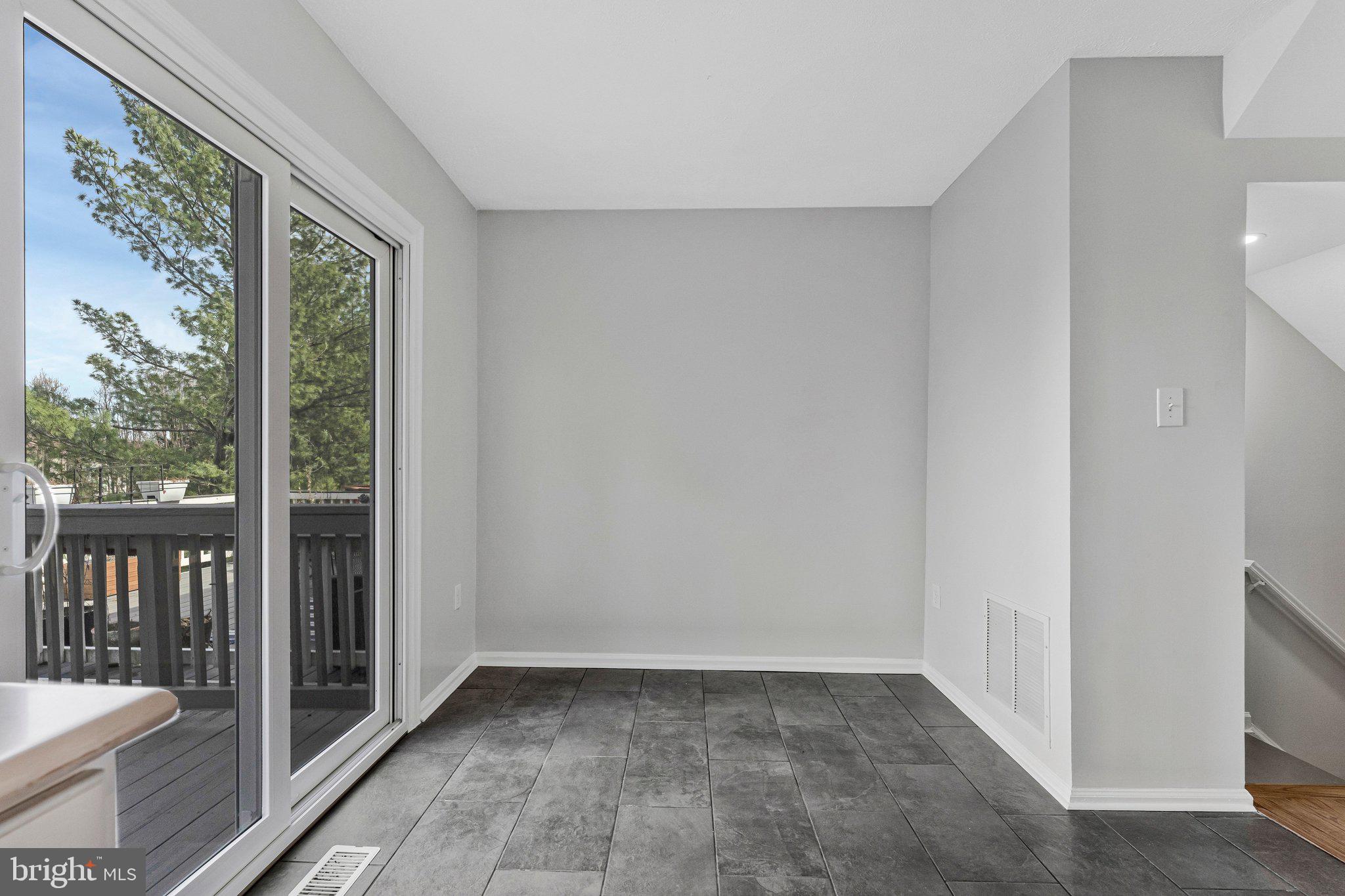 20718 Apollo Terrace Ashburn, VA 20147 - Photo 13 of 50 a view of an empty room with glass door and a window