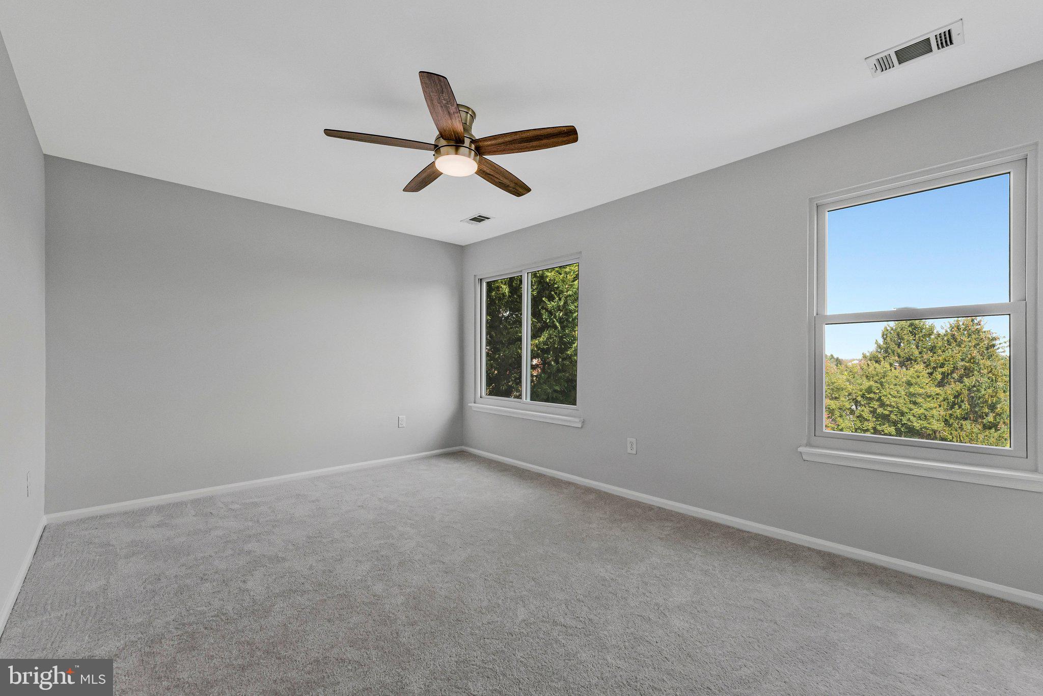 20718 Apollo Terrace Ashburn, VA 20147 - Photo 15 of 50 a view of a big room with windows and ceiling fan