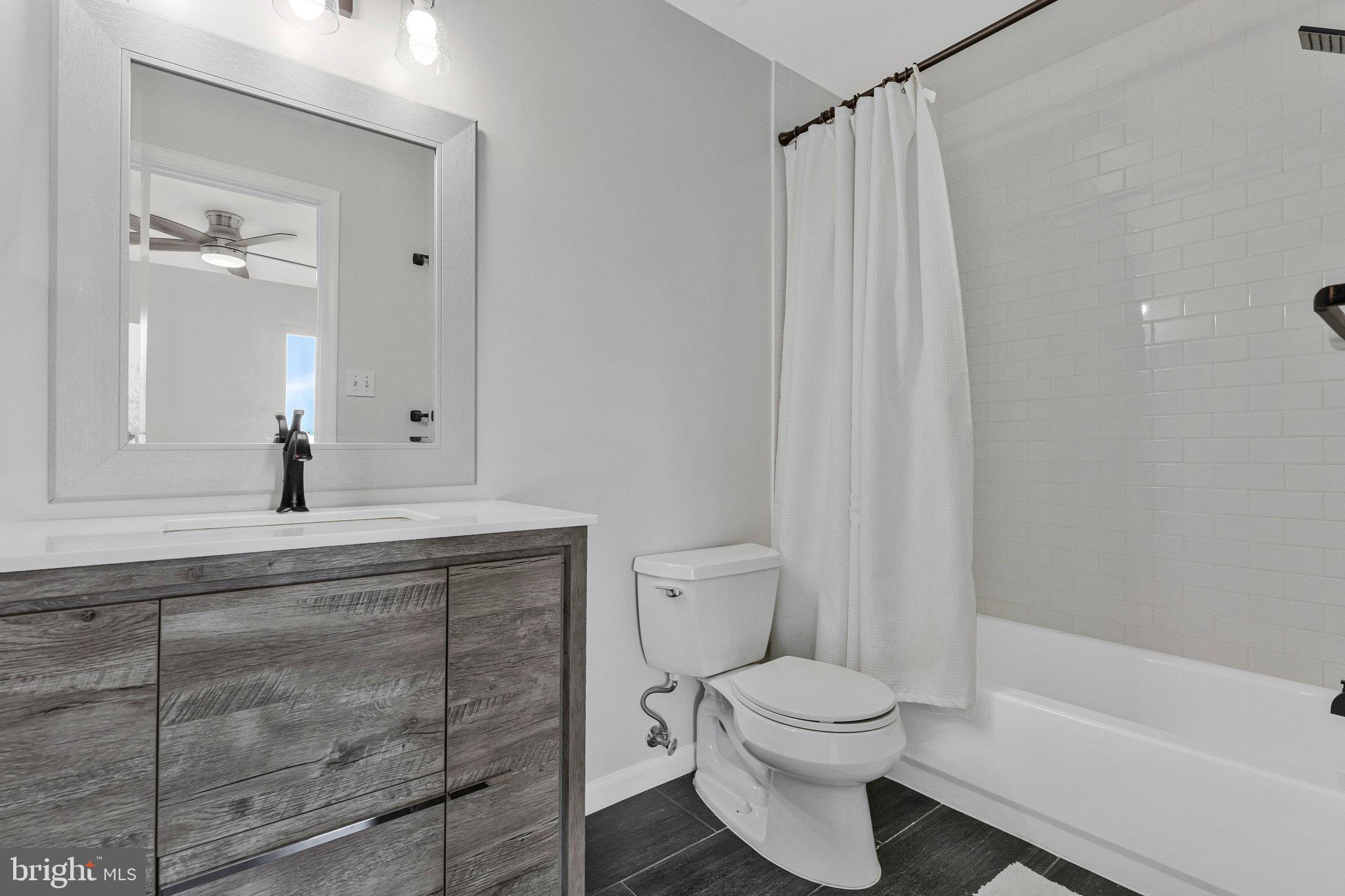 20718 Apollo Terrace Ashburn, VA 20147 - Photo 18 of 50 a bathroom with a toilet a sink and a bathtub