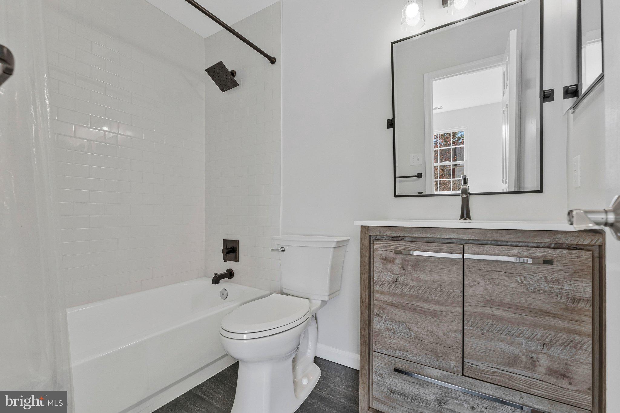 20718 Apollo Terrace Ashburn, VA 20147 - Photo 25 of 50 a bathroom with a toilet sink and mirror