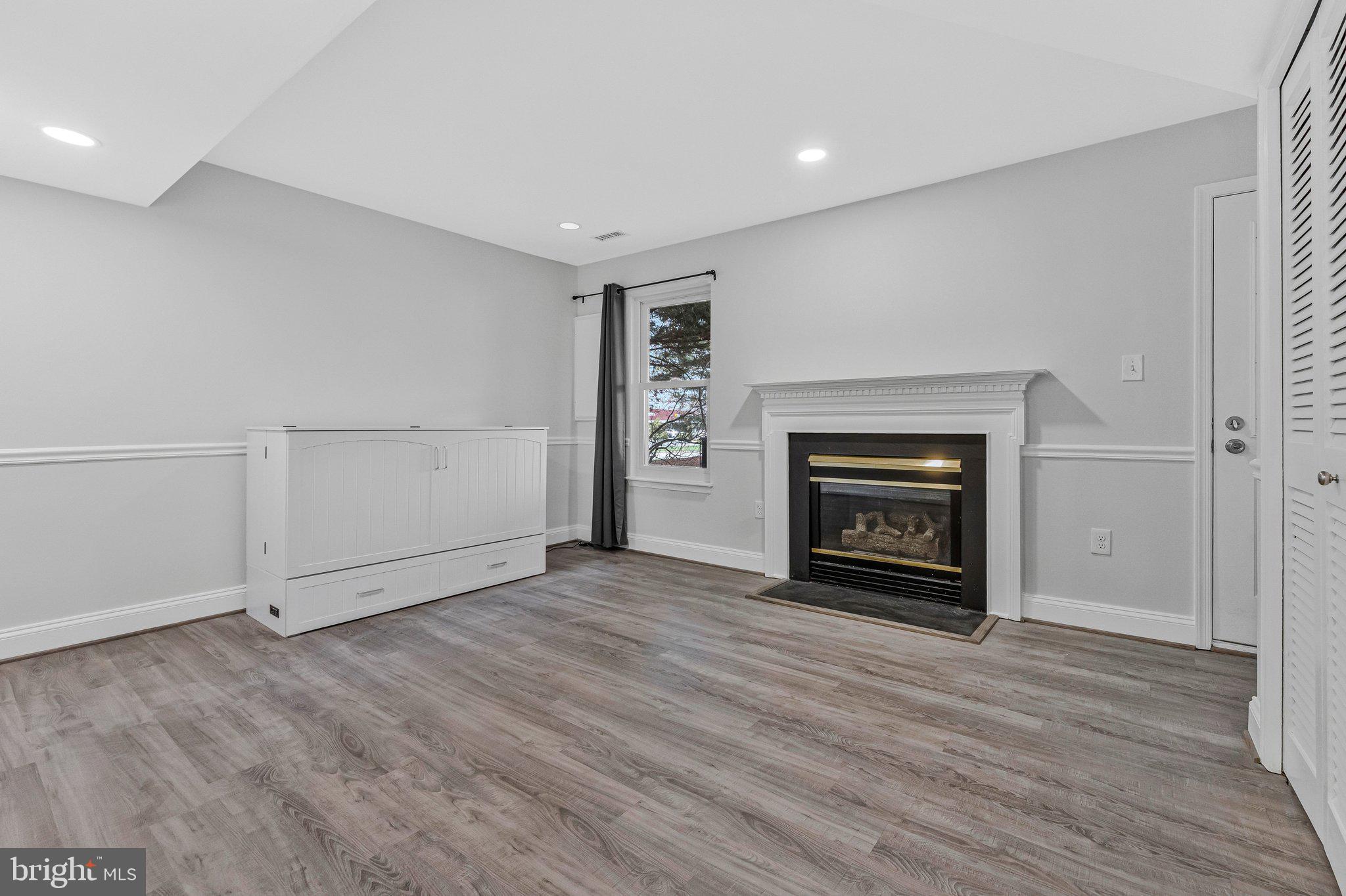 20718 Apollo Terrace Ashburn, VA 20147 - Photo 29 of 50 an empty room with wooden floor fire place and windows