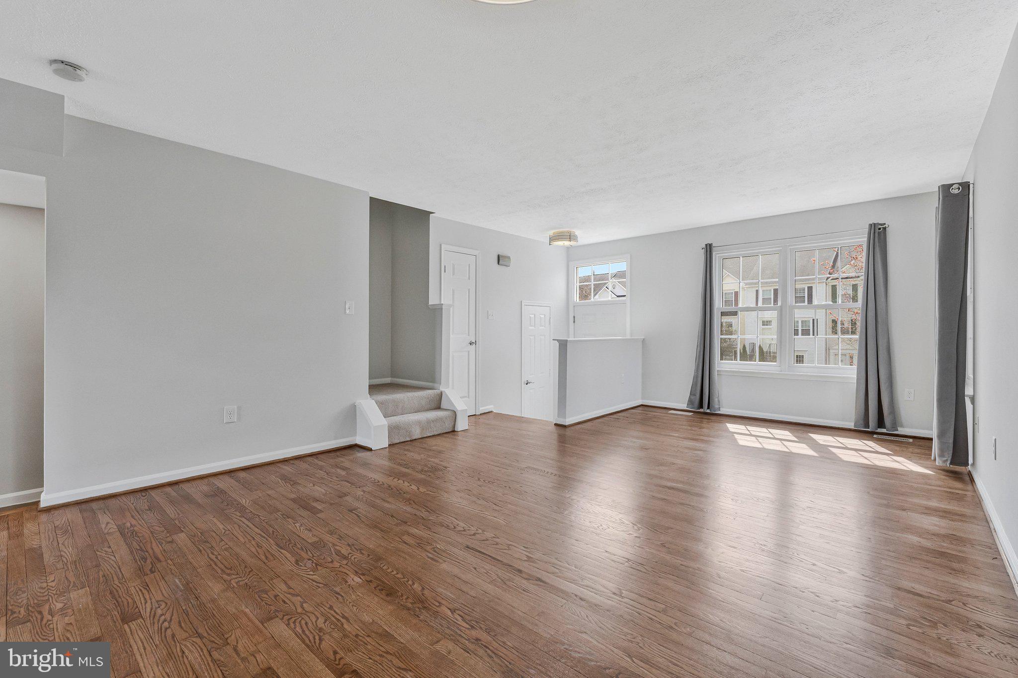 20718 Apollo Terrace Ashburn, VA 20147 - Photo 46 of 50 a view of an empty room with window and wooden floor