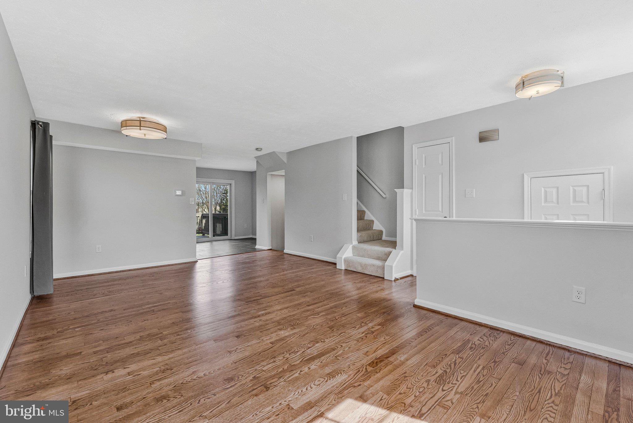 20718 Apollo Terrace Ashburn, VA 20147 - Photo 4 of 50 a view of empty room with wooden floor and window