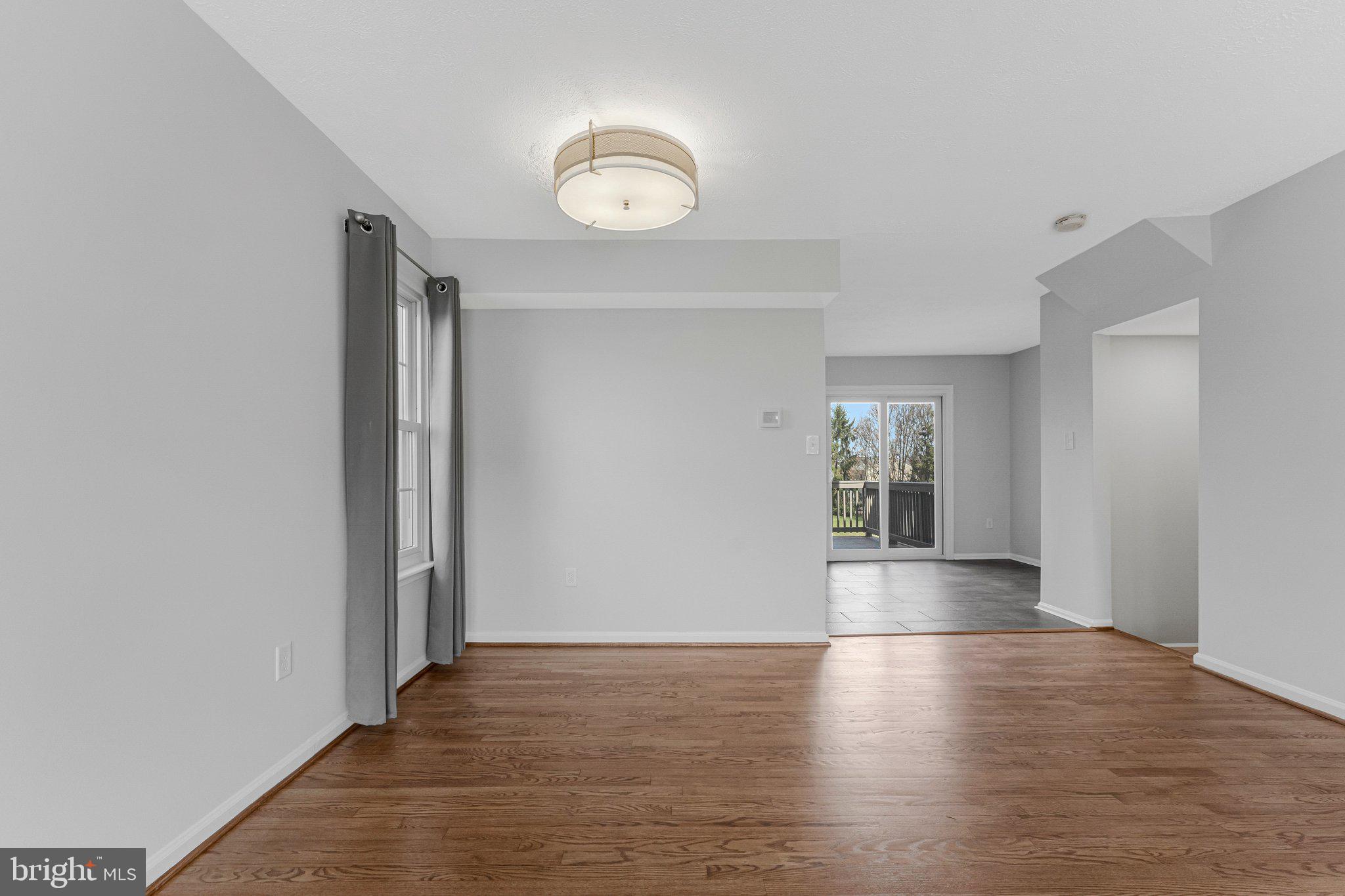 20718 Apollo Terrace Ashburn, VA 20147 - Photo 5 of 50 an empty room with wooden floor and windows