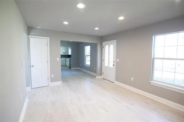 an empty room with windows and closet