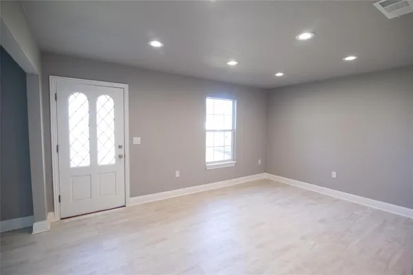 an empty room with windows and closet