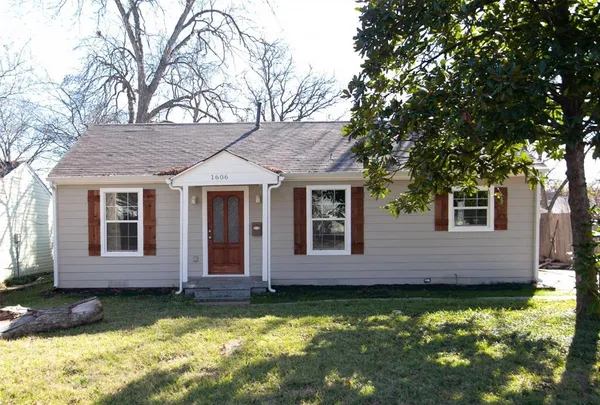 a view of a house with a large tree