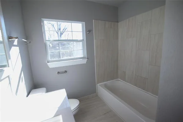 a bathroom with a bathtub and window