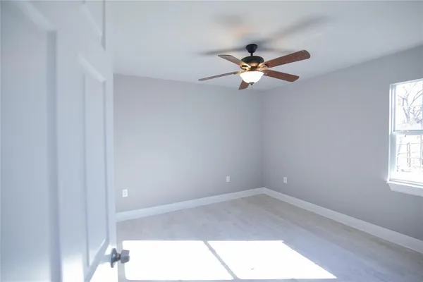 a view of workspace with a ceiling fan and window