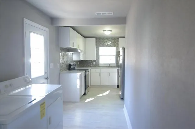 a kitchen with a sink cabinets and window