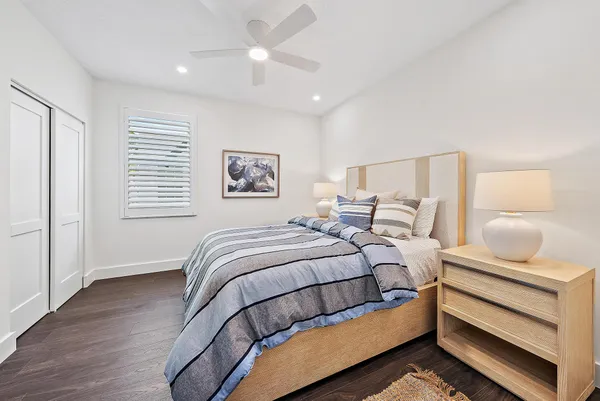 a bedroom with a white bed and a chandelier