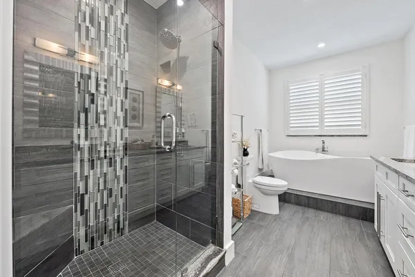 a bathroom with a toilet a sink and shower