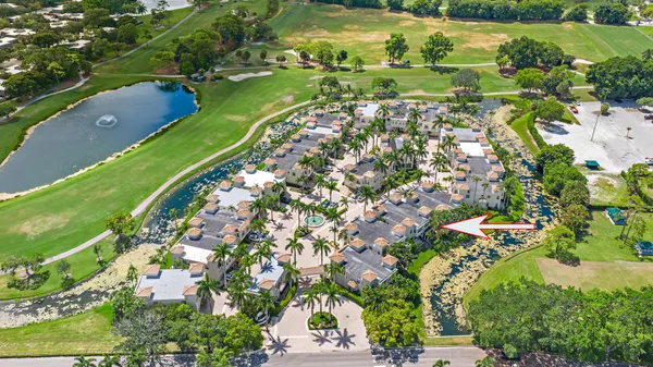 an aerial view of a residential houses with outdoor space and street view