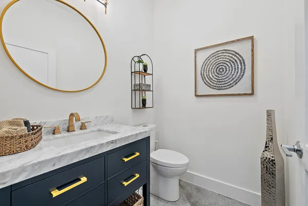 a bathroom with a toilet a sink and a mirror