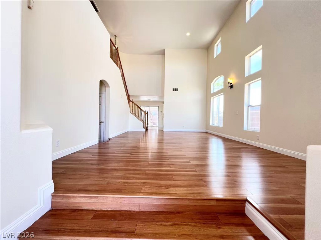 9891 Ridge Hill Avenue Las Vegas, NV 89147 - Photo 3 of 29 Natural light floods this spacious entry with gleaming hardwood floors and high ceilings.