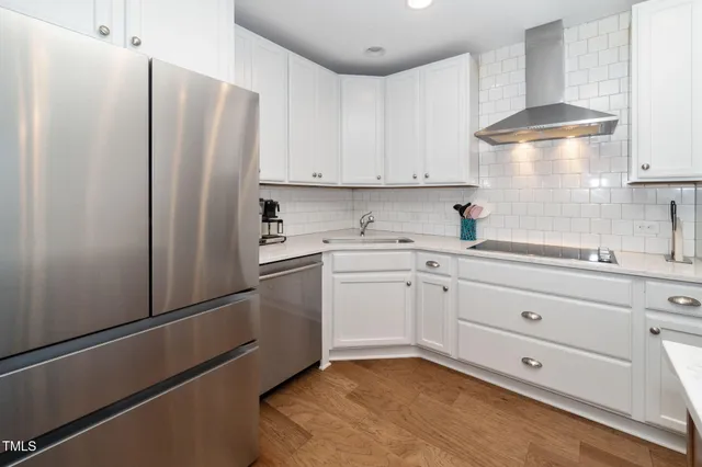 a kitchen with a refrigerator sink stove and cabinets