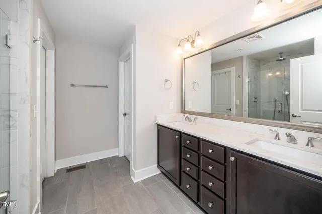 a bathroom with a double vanity sink mirror and double