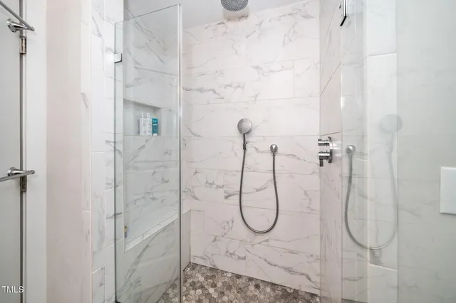 a bathroom with a glass shower door