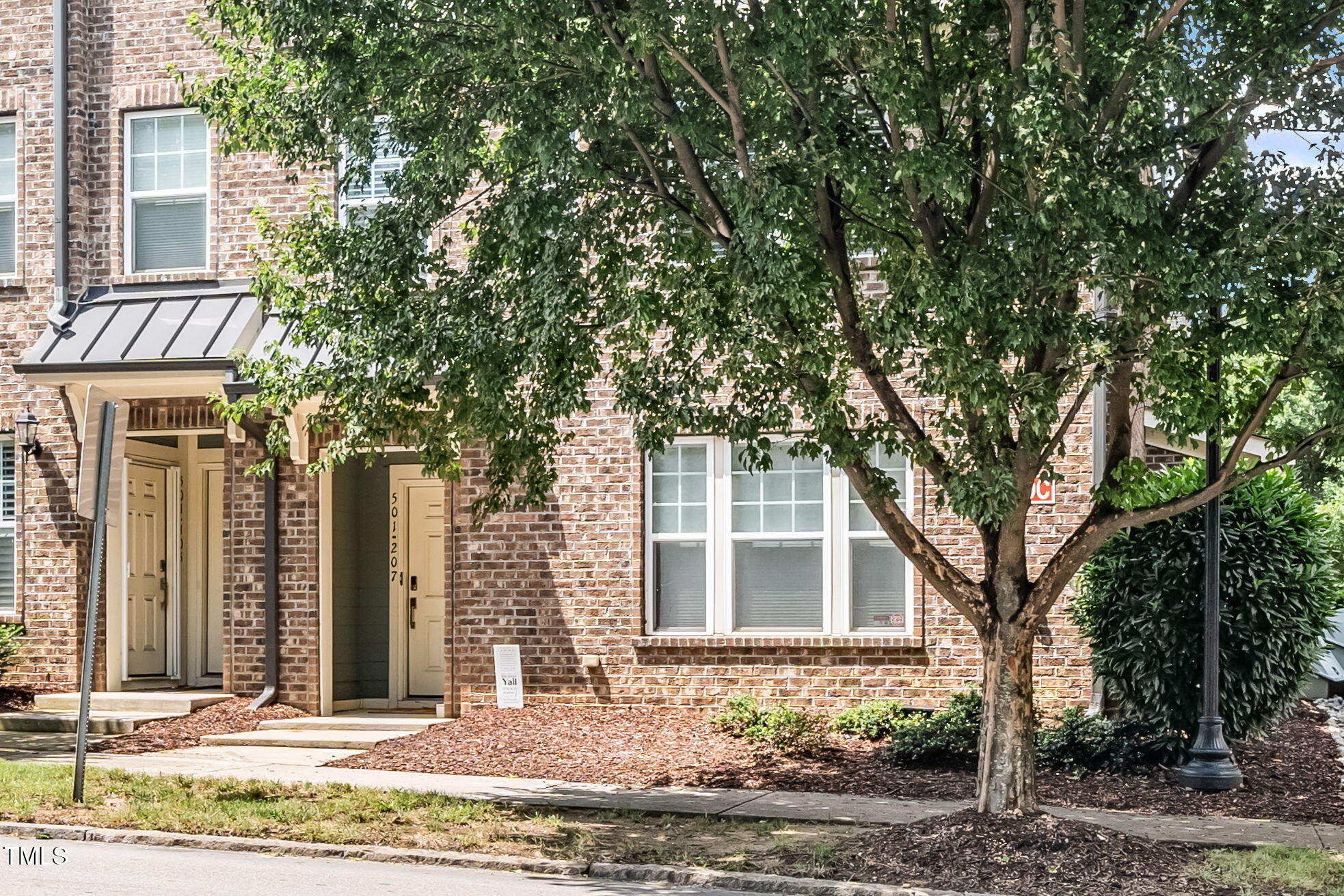 501 North Person Street, Unit 107 Raleigh, NC 27601 - Photo 2 of 30 front view of a house with a trees