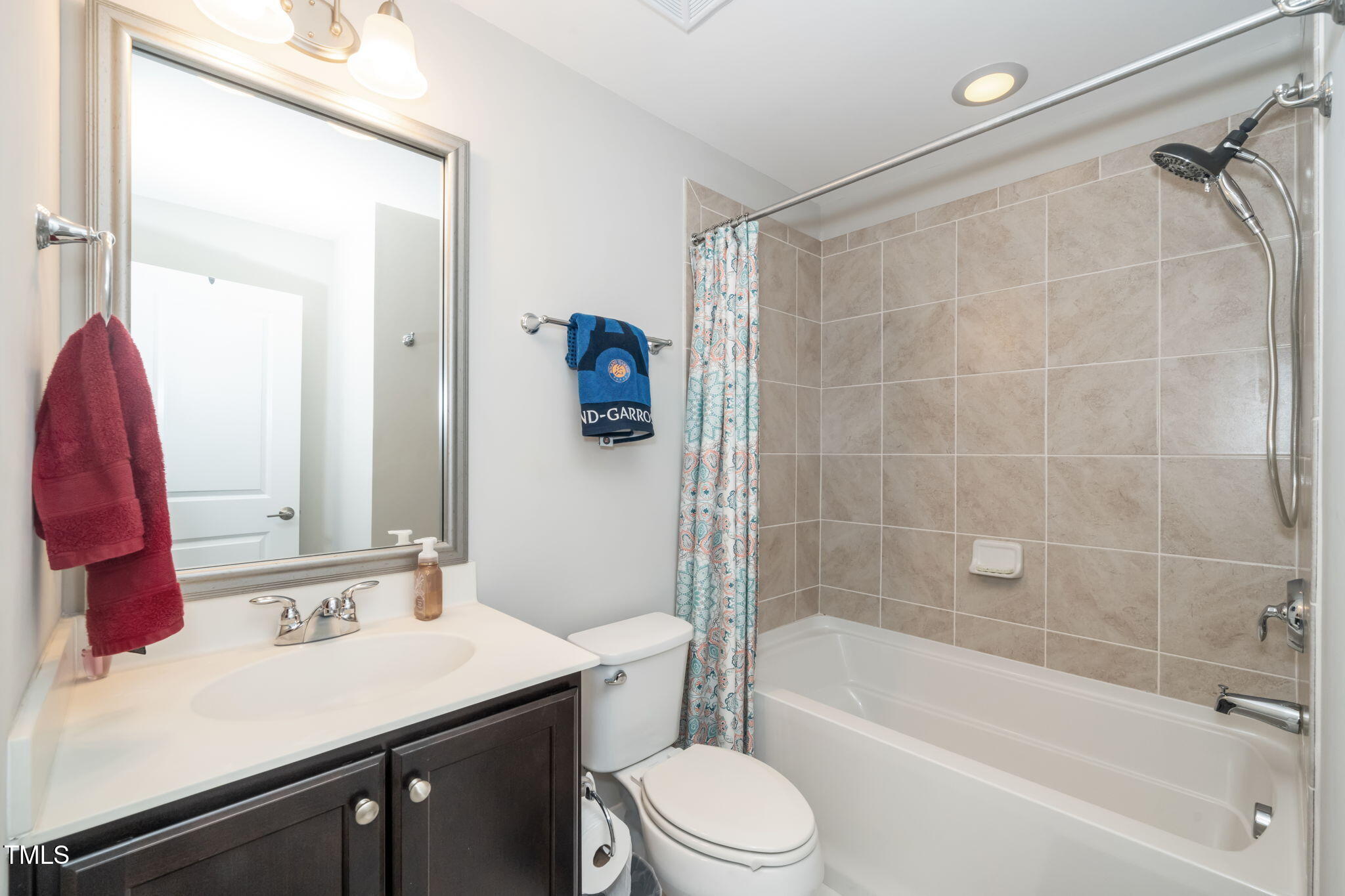 501 North Person Street, Unit 107 Raleigh, NC 27601 - Photo 24 of 30 a bathroom with a sink a toilet a mirror and shower