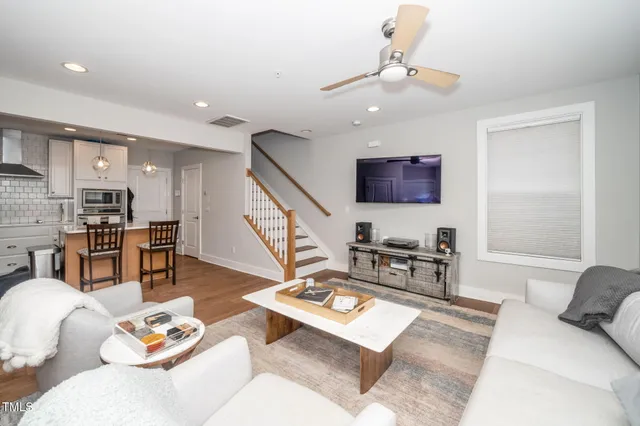 a living room with furniture and view of kitchen