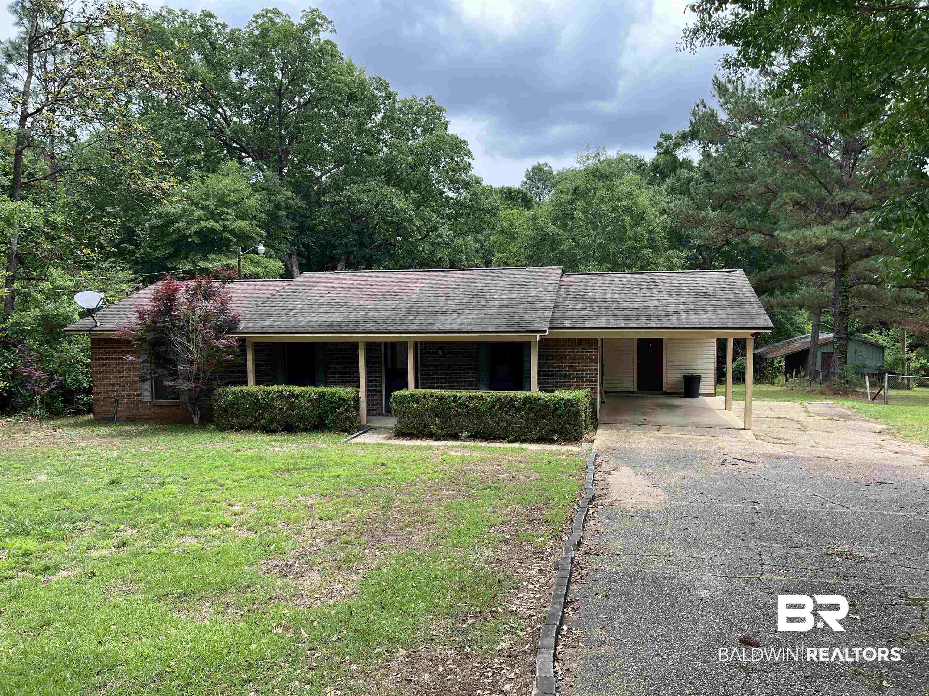 1905 Rockaway Creek Road Atmore, AL 36502 - Photo 7 of 23 Brick-front residence with a covered front porch featuring wood support columns