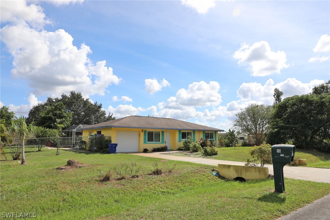 116 Florida Road Lehigh Acres, FL 33936 - Photo 3 of 30 a front view of a house with garden