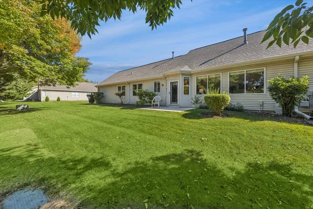 a front view of house with yard and green space