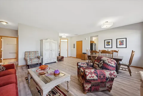 a living room with furniture a rug and a table