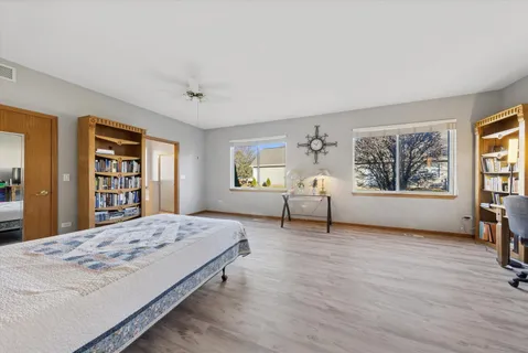 a spacious bedroom with a large bed and a window