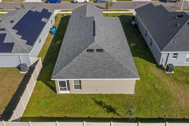 an aerial view of a house with a yard
