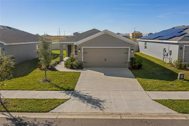 a view of a house with a backyard
