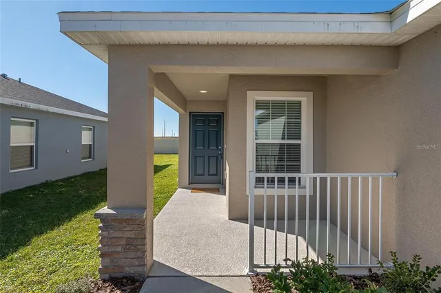 an open kitchen with wooden floor and stainless steel appliances