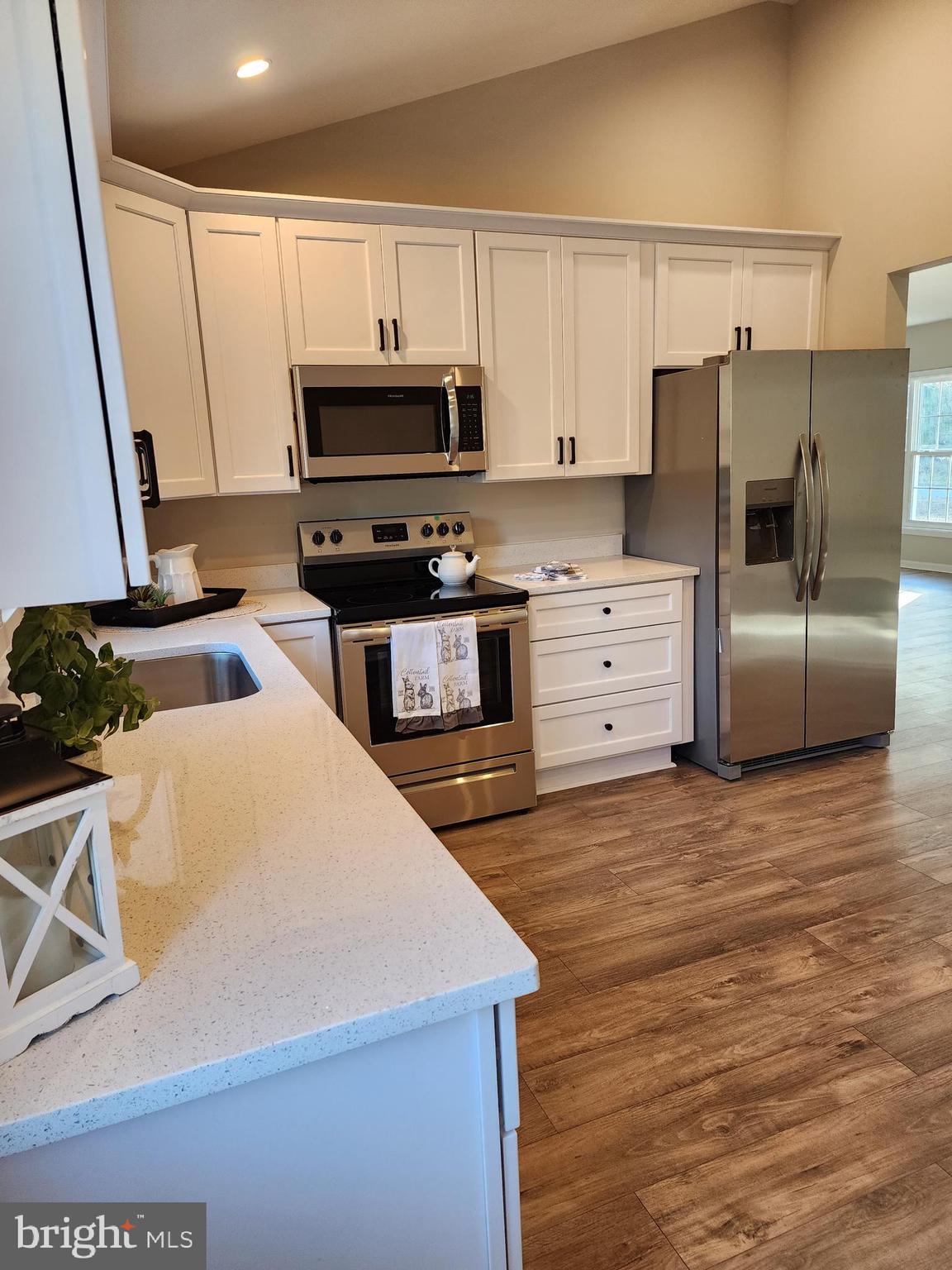 475 Bafford Road Lusby, MD 20657 - Photo 11 of 21 a kitchen with stainless steel appliances a refrigerator and a stove top oven