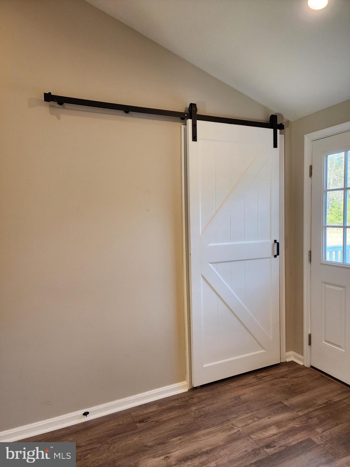 475 Bafford Road Lusby, MD 20657 - Photo 13 of 21 a view of an empty room with wooden floor and a window