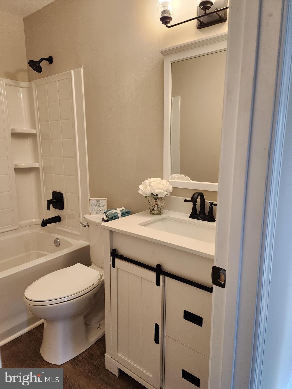 475 Bafford Road Lusby, MD 20657 - Photo 15 of 21 a bathroom with a sink a toilet and a mirror