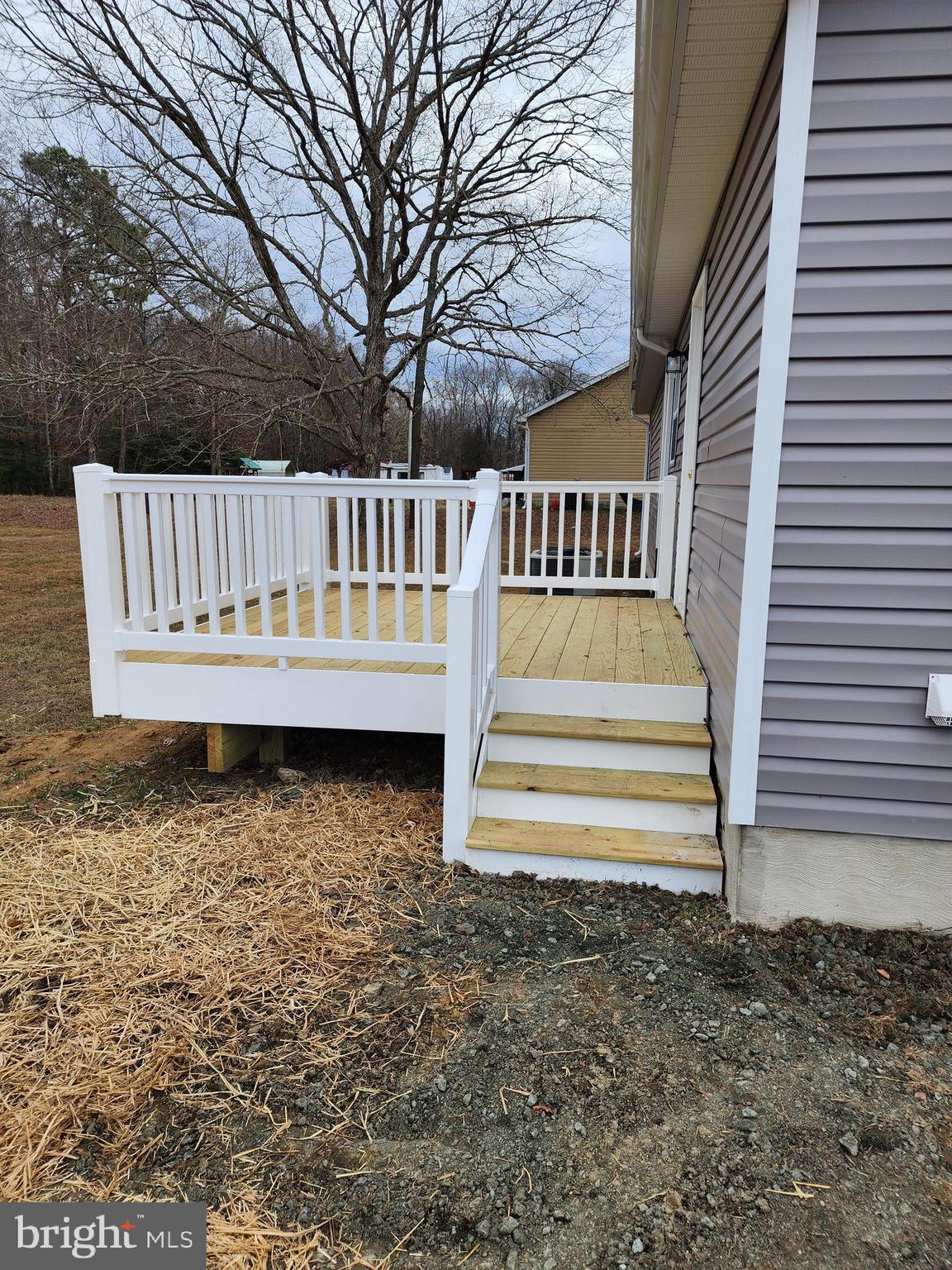 475 Bafford Road Lusby, MD 20657 - Photo 6 of 21 a view of a deck with a chair and floor to ceiling window