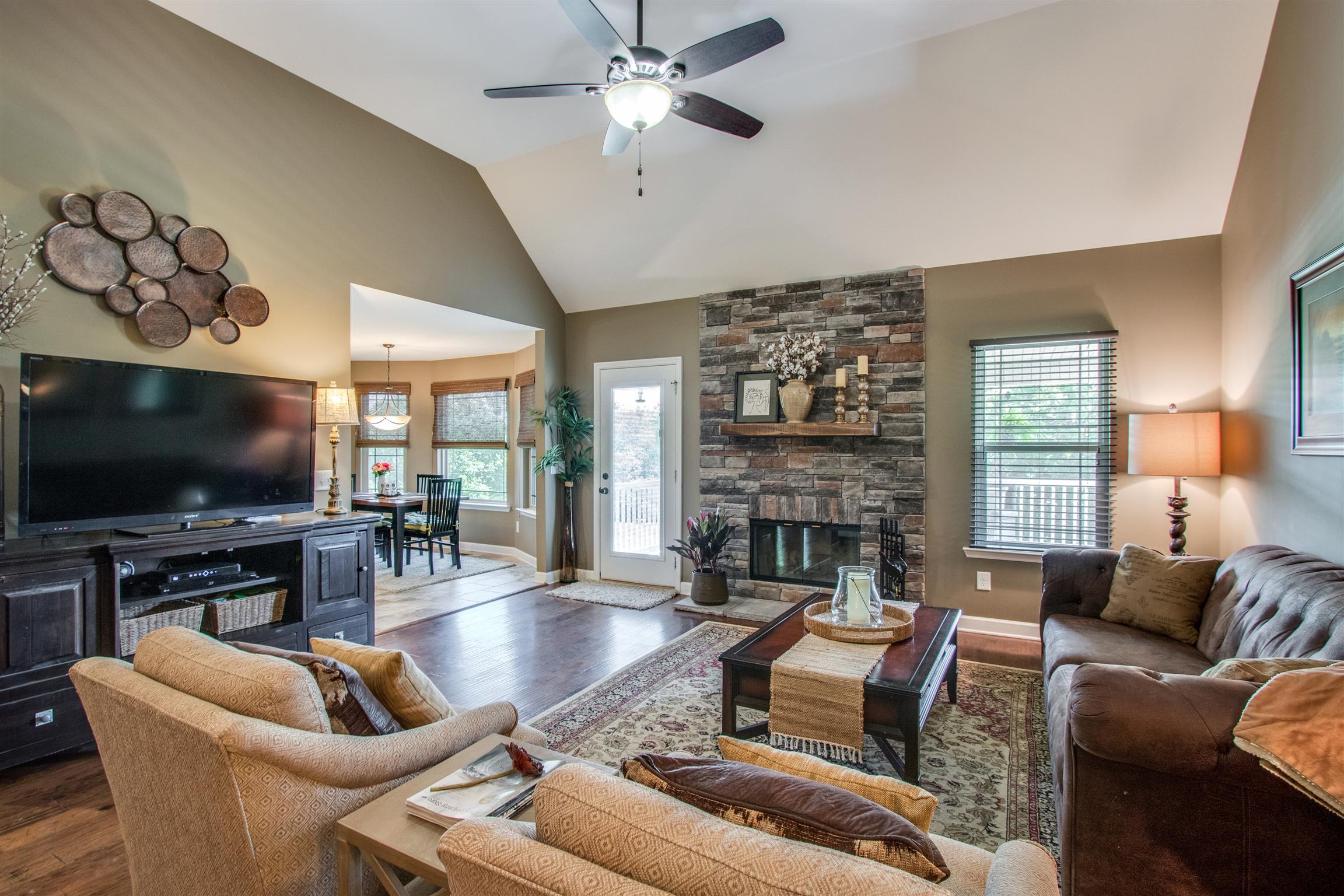 719 Sugar Flat Road Lebanon, TN 37087 - Photo 4 of 30 a living room with furniture a flat screen tv and a fireplace