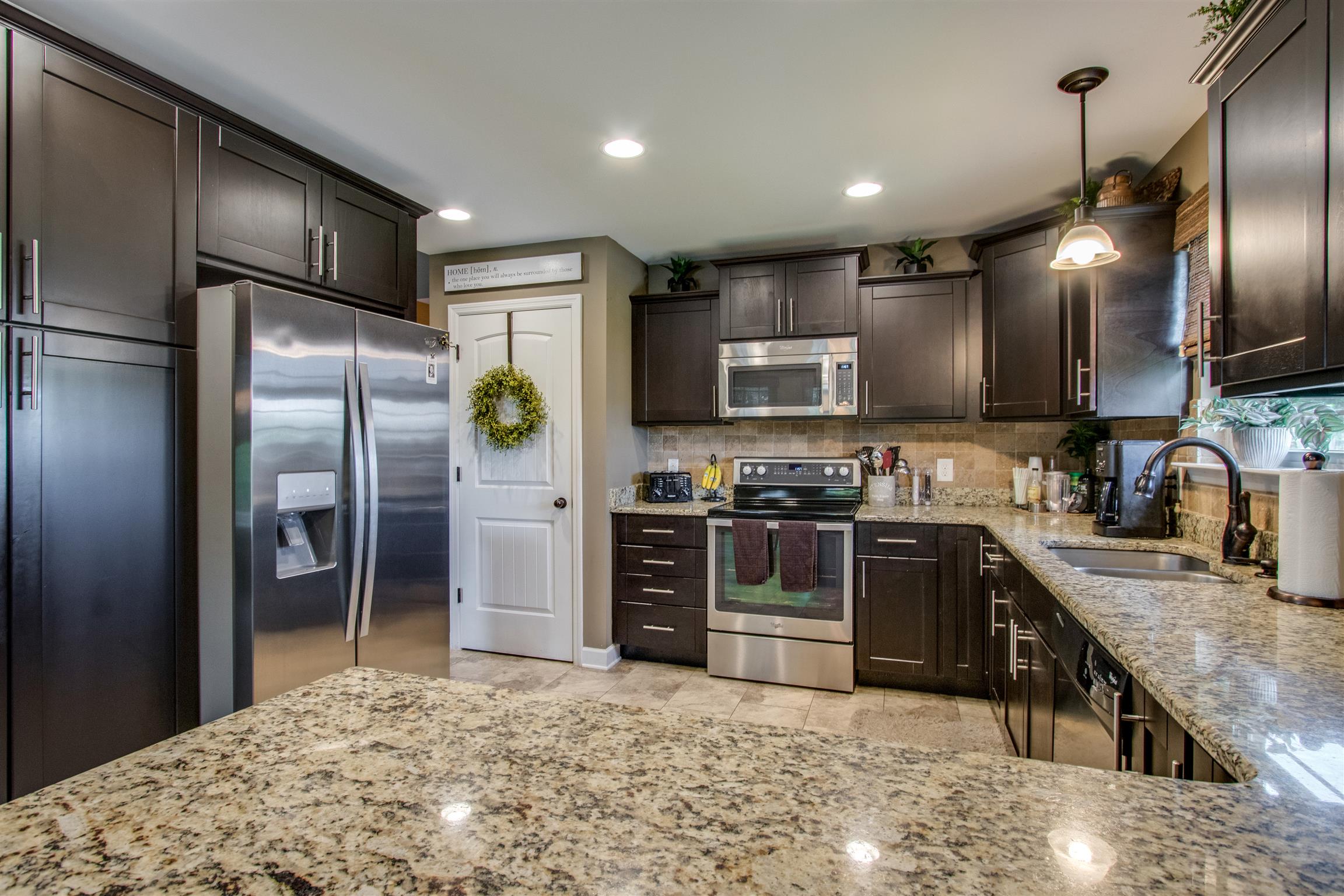 719 Sugar Flat Road Lebanon, TN 37087 - Photo 8 of 30 a kitchen with stainless steel appliances granite countertop a refrigerator a stove and a sink