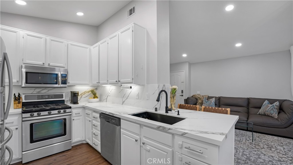 250 Chaumont Circle Lake Forest, CA 92610 - Photo 1 of 28 a kitchen with a microwave a stove and cabinets